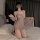 Woman kneeling on bed wearing plus size sexy lingerie set with lace trim sheer slip dress and matching robe.