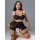 Woman modeling black sheer mesh lace lingerie set with thigh rings, featuring a bra, garter belt, and stockings.