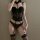Womens black lace mesh shapewear set with cut-out bodysuit, garter straps, and thigh-high stockings in style.