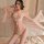 Woman wearing yaqin nu vintage belly dance set with embroidered doudou top, sheer outerwear, and matching lingerie.