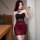 Woman in black and red sheer mesh bodycon dress with 3d floral halter top, taking a mirror selfie.