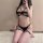 Sexy black 4-piece lingerie set with underwire bra, bondage straps, and thigh rings.