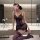 A woman poses in a luxurious bathroom wearing a purple lace sheer sleep dress. the off-shoulder design features floral trim a...