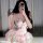 A woman poses with a leopard phone case, wearing a shimmering pink corset dress paired with a voluminous tutu skirt. the outf...