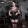 A woman poses in a leopard print secret lingerie set, featuring a lace-trimmed thigh-high stocking and a plunging neckline, e...