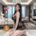 A woman poses in a luxurious setting wearing a black lace sleepwear set, featuring a sheer chemise and matching briefs, ideal...