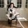 A woman poses elegantly in a qingshe jk flirty lingerie set, featuring a pleated skirt with a navy bow and white stockings, e...