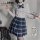 A stylish ensemble featuring a white blouse with a bow tie, paired with a blue plaid skirt, perfect for a schoolgirl look.