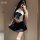 A person wearing a white crop top with a navy blue bow and pleated skirt, paired with sheer stockings, posing for a mirror se...