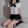Sexy innocent schoolgirl lingerie set featuring a pleated mini skirt, sailor-style top with bow, and knee-high socks, perfect...