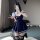 A person wearing a navy blue school uniform-style dress with white trim, featuring a pleated skirt, bunny ears, and a badge e...