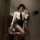 A woman poses in a zimei sexy nightwear set, featuring a white blouse with a black tie, paired with a black mini skirt and sh...