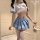 A stylish young woman models a blue and white schoolgirl uniform set, featuring a pleated skirt with silver stripes, a sailor...