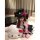 A woman poses with a hello kitty plush toy, wearing a cute maid costume set featuring playful elements and vibrant colors. th...