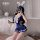 A woman poses in a navy blue domoira jk school skirt set, featuring bunny ears and a bow, perfect for date night or club wear...
