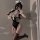 A woman poses in a black maid costume set featuring lace details, perfect for cosplay or themed events. includes sleepwear an...