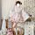 A woman poses in a sweet lolita maid dress set, featuring a floral-patterned kimono with ruffles and a matching apron. the ou...