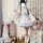 A woman models a sweet lolita maid dress set featuring a floral-patterned blouse, apron, and ruffled skirt, perfect for cospl...