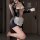 A woman poses in a black sheer mesh maid costume set featuring lace details and a ripped design, holding a white cup.