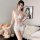 A woman poses in a sheer lace bodysuit with an open-crotch design, featuring delicate floral patterns. the outfit includes a ...