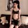 A woman models a black lace bodysuit with sheer fabric and floral patterns, featuring an open-crotch design, perfect for inti...