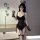 Woman modeling black rabbit girl lingerie set with underwire bra, padded cups, bunny ears, gloves, and fishnet stockings.