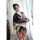 A woman wears a black floral japanese kimono-style lingerie set, holding a fan, exuding elegance and playfulness. perfect for...