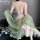 A woman wears a vintage floral lace chemise set with a sheer green shawl, featuring a seductive no-remove design.