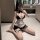 Woman posing in suoqing maid costume set — cute 6-piece lingerie outfit with lace trim, apron & garters.