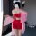 A woman poses in a red bodysuit paired with a sheer pink robe, embodying a fox spirit theme. the set features intricate desig...