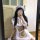 A person wearing a plus-size maid costume, featuring a ruffled hem, cute apron, and headband, posing for a mirror selfie.