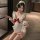 Playful maid costume featuring a sexy backless apron with ruffled trim, perfect for women seeking an elegant yet daring look.
