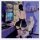 A person wearing a sensual lace blindfold mask sits on a gaming chair, facing a computer screen with an anime wallpaper. the ...