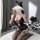 A woman poses playfully with a cloud-shaped object covering her face, wearing a black lace bodysuit featuring an open-crotch ...