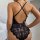 Sensual lace bodysuit with deep v-neckline and intricate floral patterns, offering sheer elegance and allure. perfect for int...