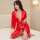 A woman poses elegantly in a vibrant red ice silk robe, featuring lace detailing and a deep v-neckline, perfect for luxurious...