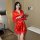 A woman stands elegantly holding a rose, wearing a vibrant red ice silk robe with lace detailing. the luxurious bathrobe exud...