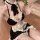 A woman wearing a maid costume lingerie set, featuring black and white ruffled details, perfect for cosplay or sleepwear.