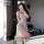 Woman posing in a sheer lace tie-up sensual lingerie set featuring an 8-petal skirt and adjustable straps, perfect for intima...
