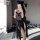 Woman taking selfie in sheer mesh lace tie-up sensual lingerie set featuring 8-petal skirt, breast-baring design, and adjusta...
