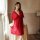 A woman models a plus-size sheer red lingerie set, featuring delicate lace details and a flowing design, perfect for sensual ...