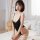 A woman wearing a black 72d ice silk sexy swimsuit, featuring a deep v-neckline and thin straps, designed for summer wear wit...