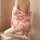 A woman wears a pink floral dorothy plus size japanese vintage kimono lingerie, featuring sheer sleeves and a sexy corset des...