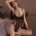 Woman wearing black lace bodysuit with sheer panels and open-crotch design, elegant lingerie set 7425.