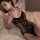Woman wearing black lace bodysuit with sheer floral pattern and open-crotch design, styled as seductive lingerie set 7425.