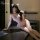 Woman wearing pure & alluring lingerie set with cat ears, posing seductively on desk for date night allure.