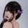 A person with long black hair adorned with purple floral hair clips, featuring elegant designs perfect for buns, side braids,...