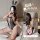 Woman wearing rabbit girl lingerie set - sheer black bodysuit with lace trim, bunny ears, and fishnet stockings.