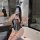 Woman wearing rabbit girl lingerie set - sheer open-crotch bodysuit with bunny ears, posing in bathroom mirror selfie.