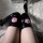 Shiny black over-the-knee socks featuring cute pink cat paw prints, perfect for cosplay or adding a kawaii touch to any outfi...